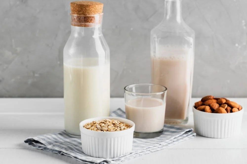 set milk bottles glasses with oatmeal almonds